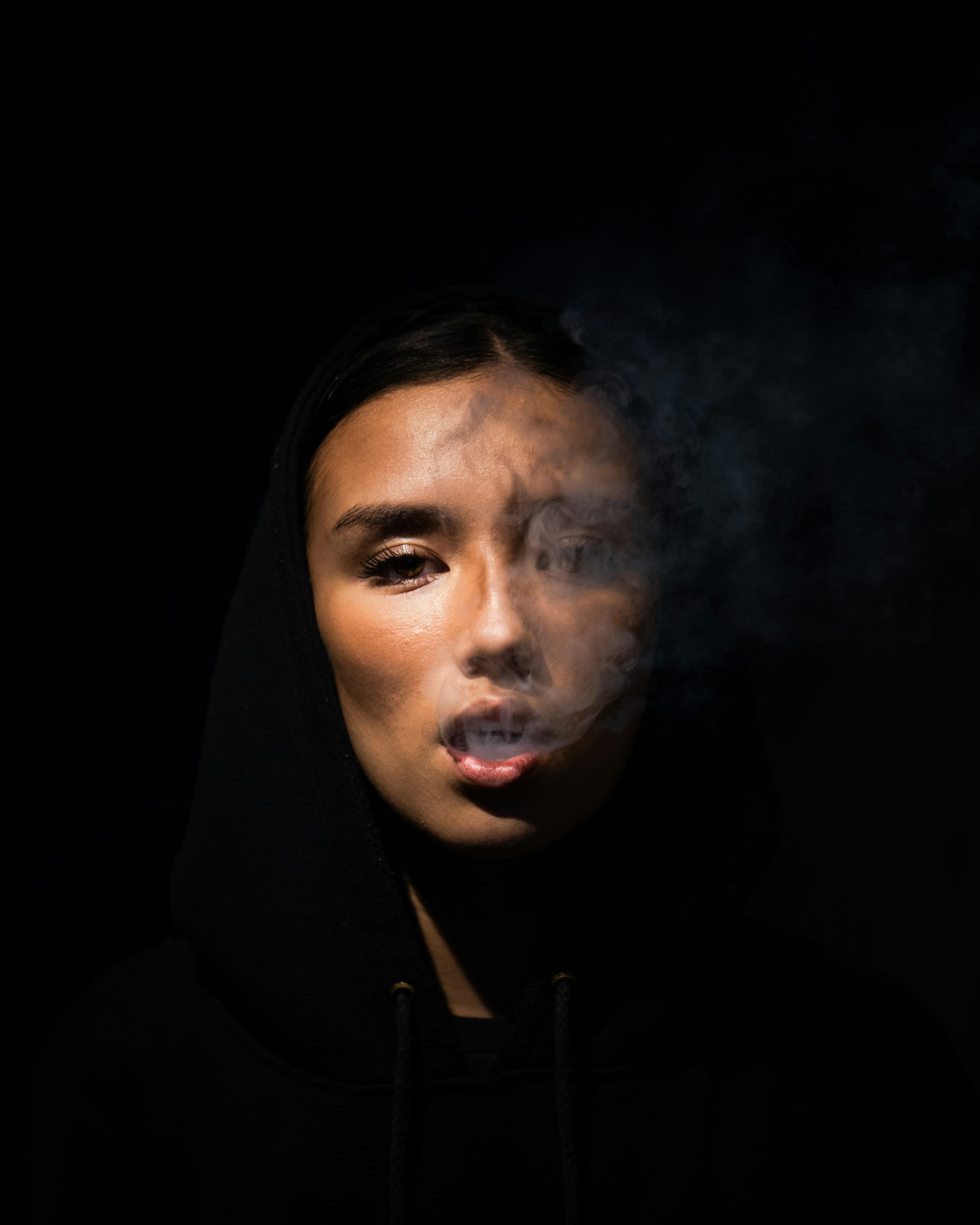 woman in black hoodie taking selfie