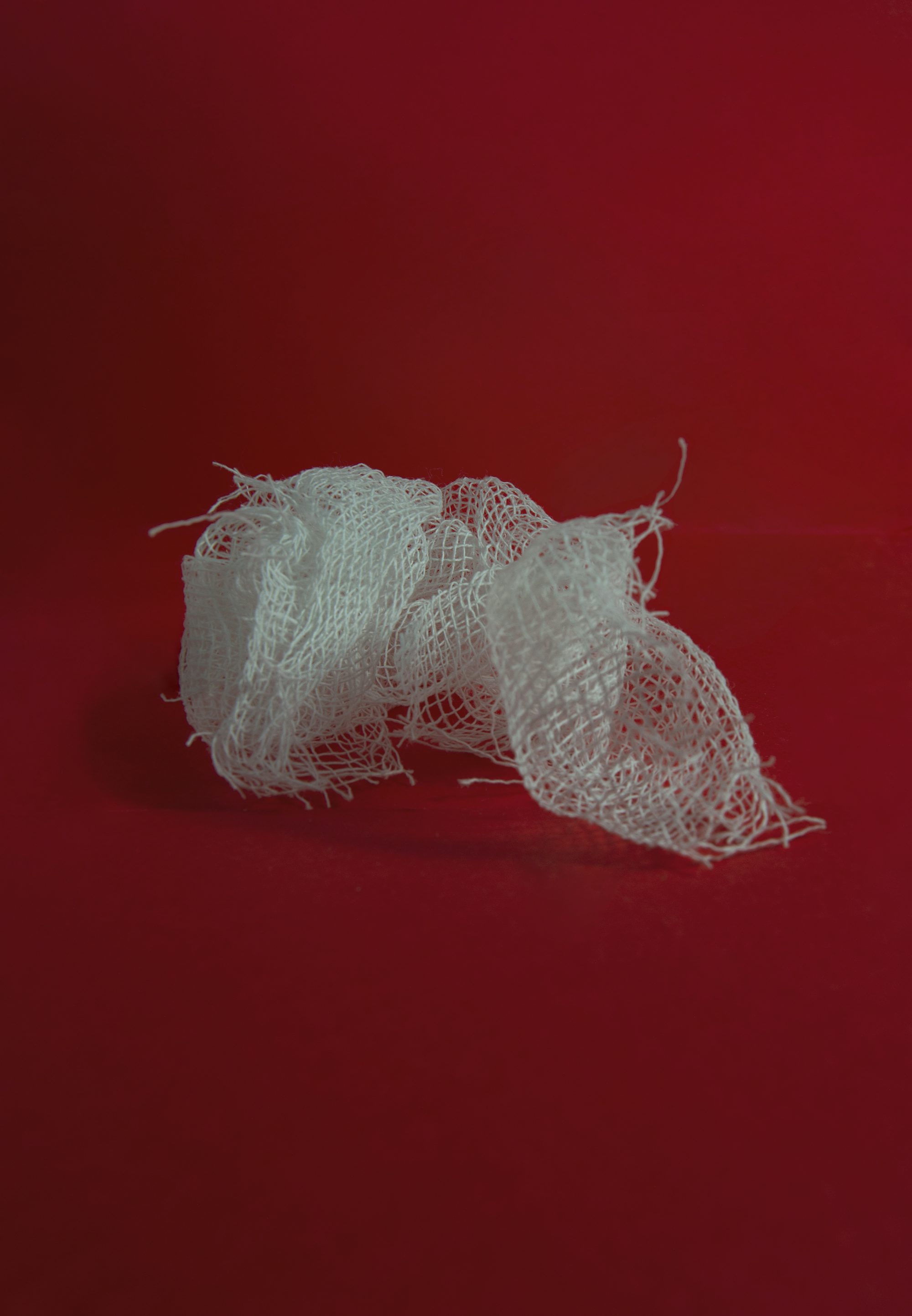 white yarn on red surface