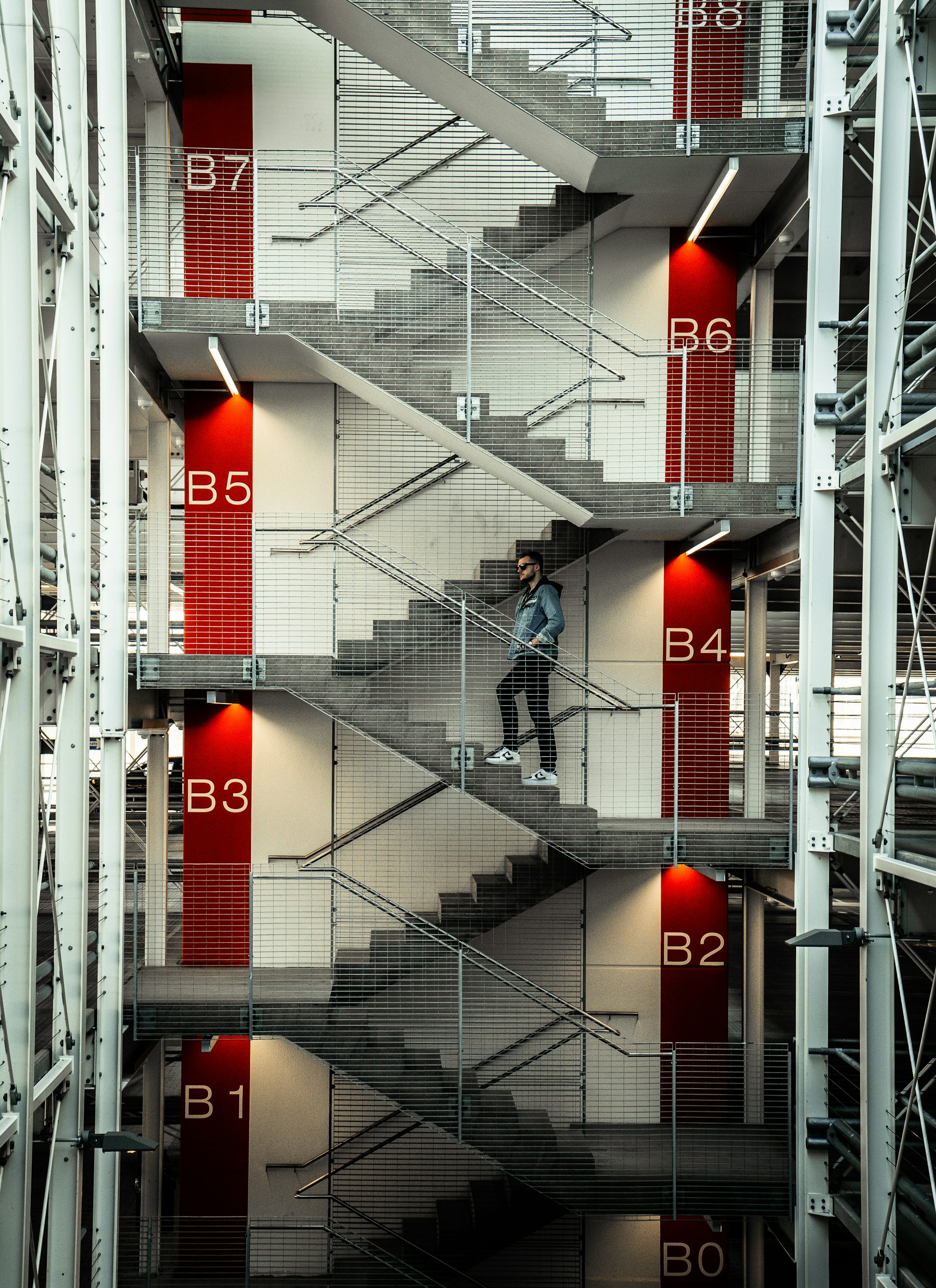 man in black jacket and pants walking on the stairs
