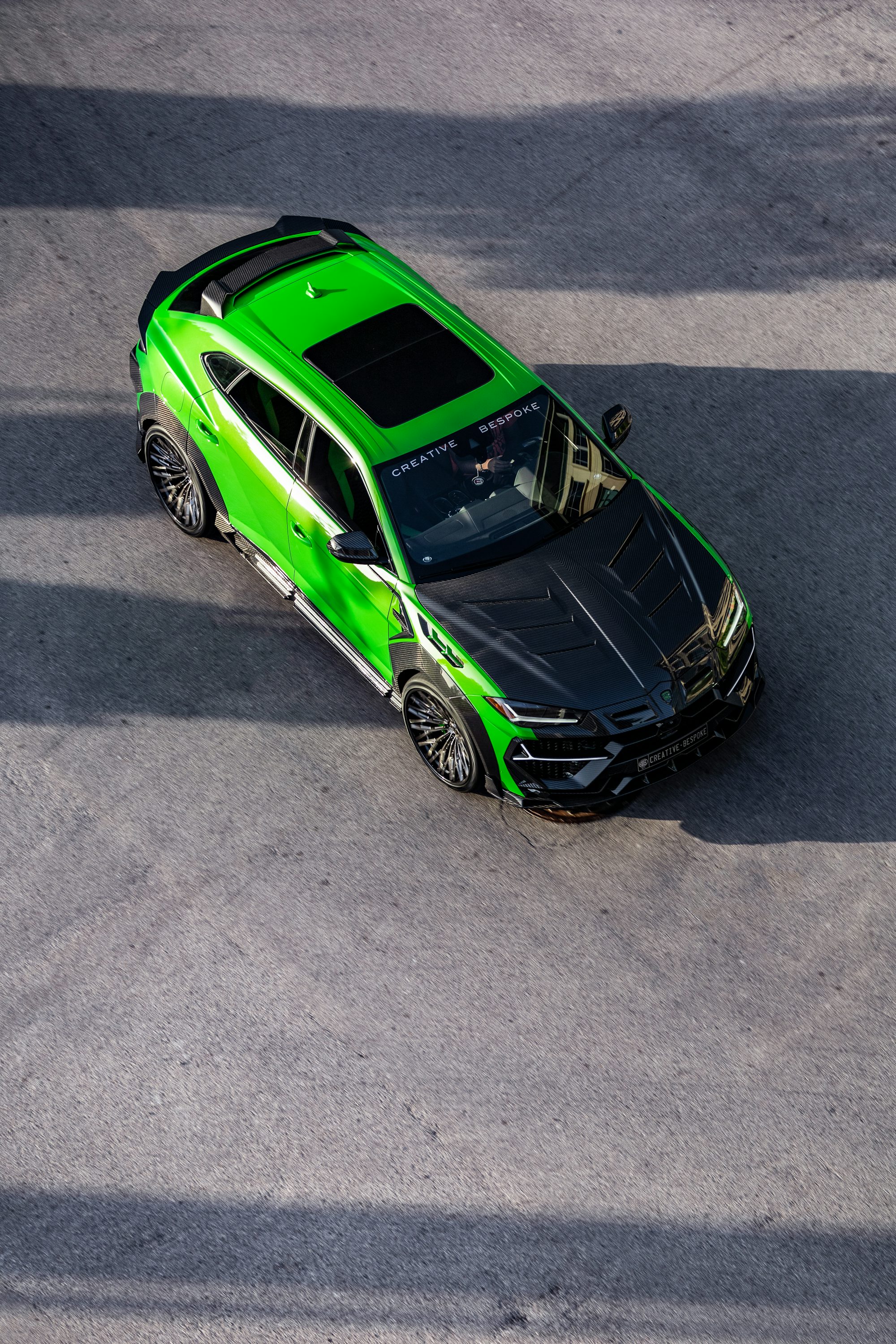 green and black porsche 911 on road