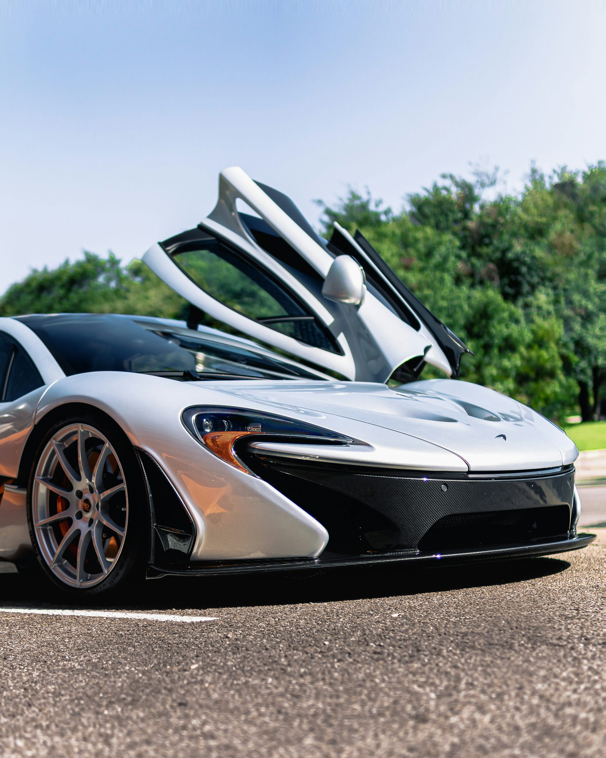 a white and black sports car parked on the side of the road