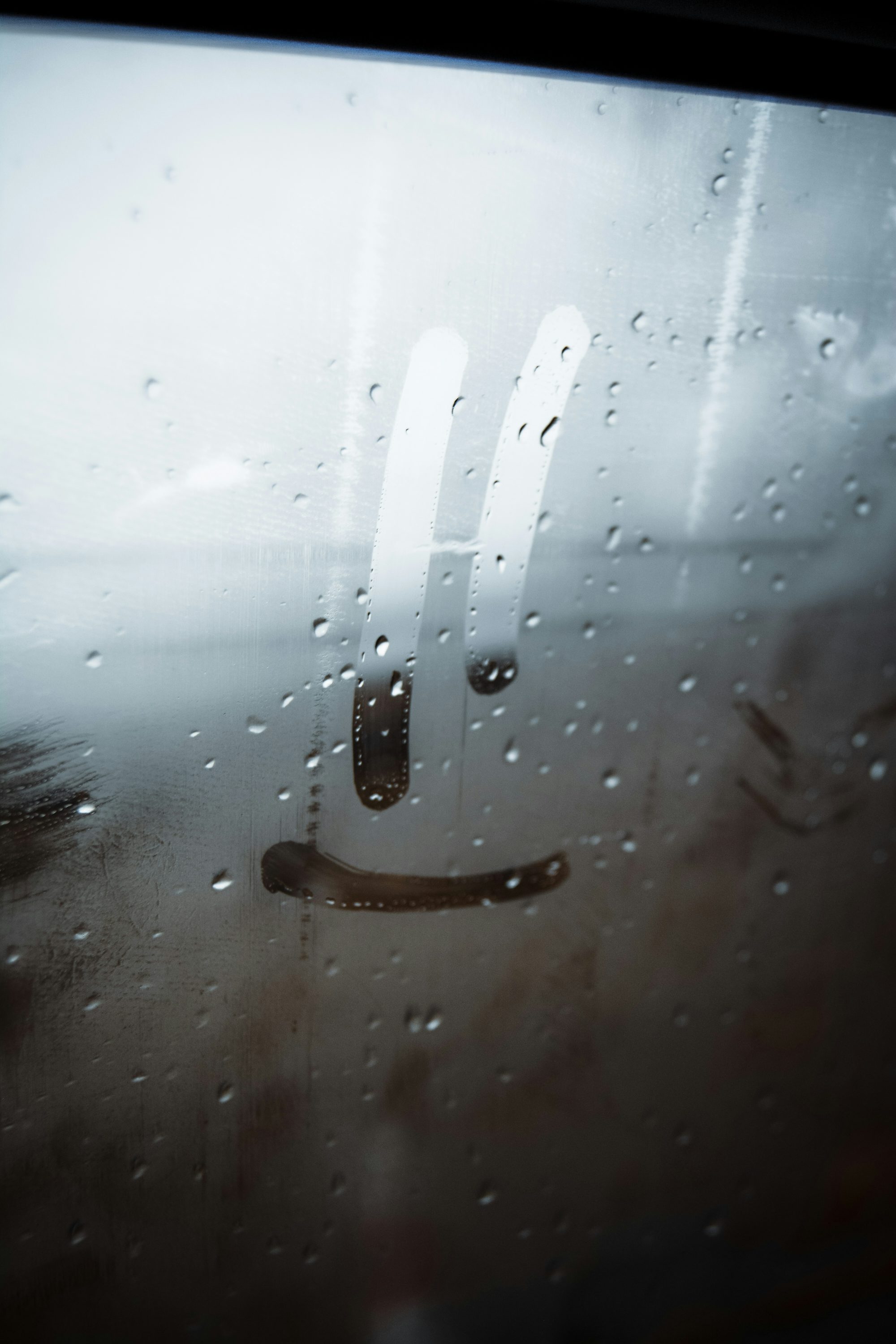 a close up of a window with rain drops on it