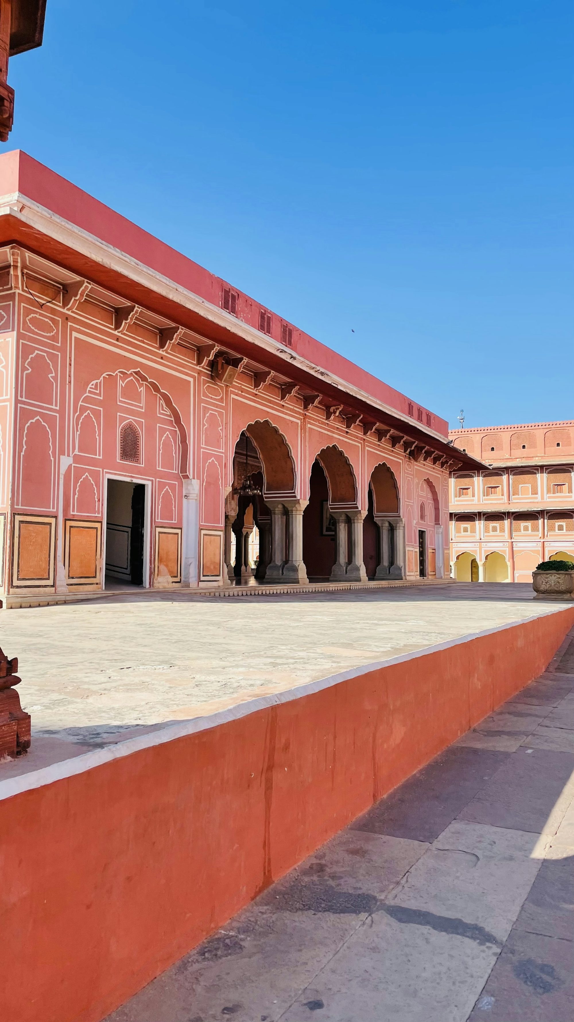 a pink building with arches and arches around it