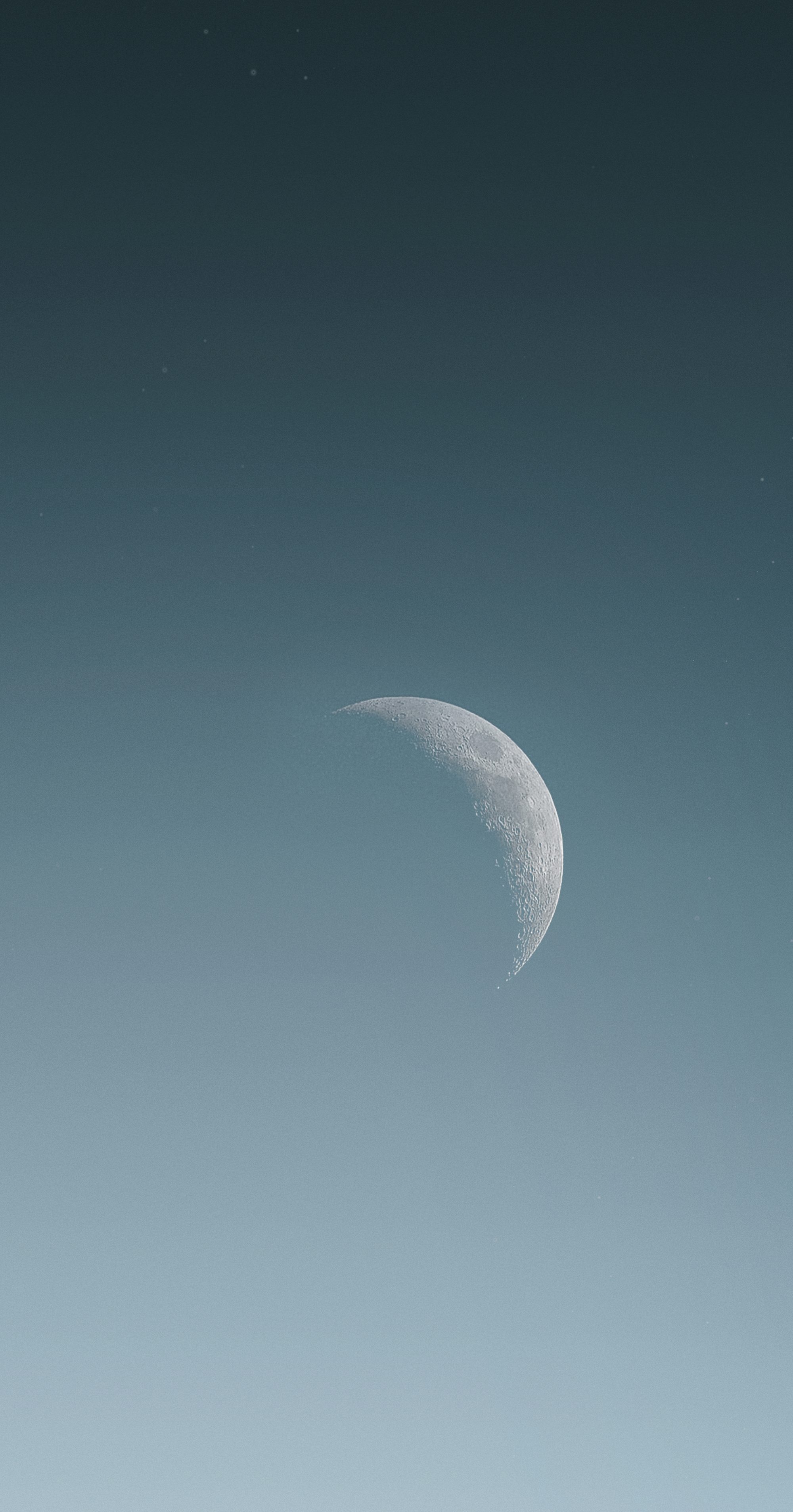 a crescent moon is seen in the sky